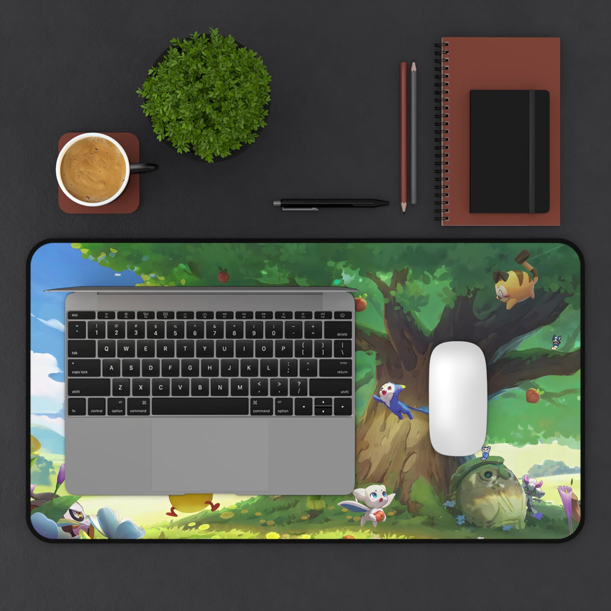 Roco Kingdom Carosia desk mat, on a desk – The Great Tree design, official Roco Kingdom merch